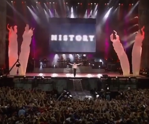 The King of Pop live on stage at the end of one of his concerts. HISTORY can be seen behind him on screen.